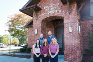 Palmetto Family Orthodontics staff standing in front of their building