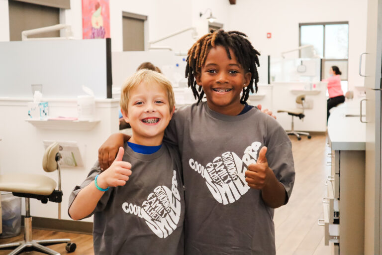 Two kids receiving airway orthodontic treatment at Palmetto Family orthodontics giving a thumbs up